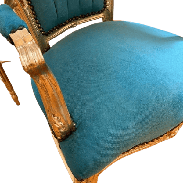 Close-up of baroque turquoise and gold dining chair velvet fabric and gold trim